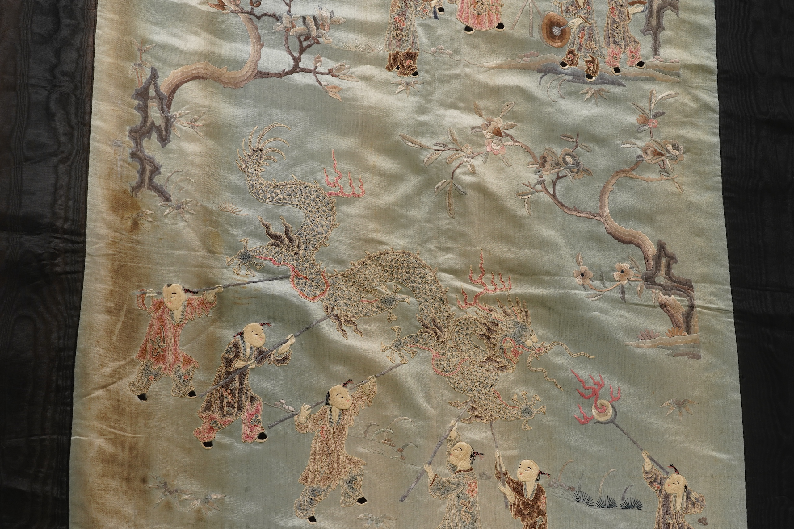 A Chinese embroidered silk ‘dragon dance’ panel, 18th/19th century